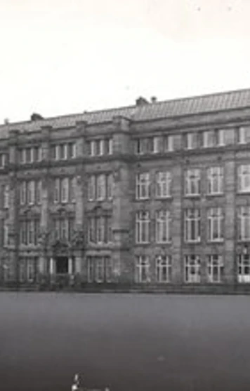 Black and white photograph of the original North Glasgow College building, showcasing its grand early 20th-century architectural style with ornate stonework and large sash windows. Black and white photograph of the original North Glasgow College building, showcasing its grand early 20th-century architectural style with ornate stonework and large sash windows.